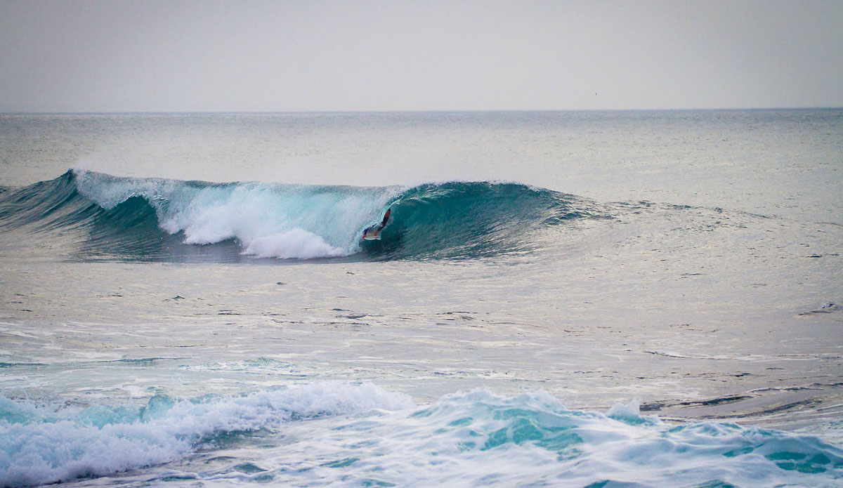 Greg sneaks under a folding ocean.  Photo: <a href=\"https://www.facebook.com/pages/Pho-Tye-Studio/398591356893177?fref=nf\"> Tyerell Jordaan</a>