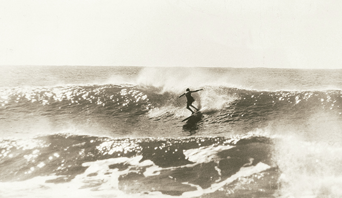 Nat at Collaroy c. 1961. I’d borrowed a camera and telephoto lens from my friend Ron Perrott who was one of the pre-eminent Australian surf photographers of the day. We happened to be at Collaroy in Sydney, and a gangly kid nicknamed Gnat happened to be in the water. Not a bad subject for your first surfing pictures. Photo: <a href=\"https://www.johnwitzig.com.au/\">John Witzig</a>