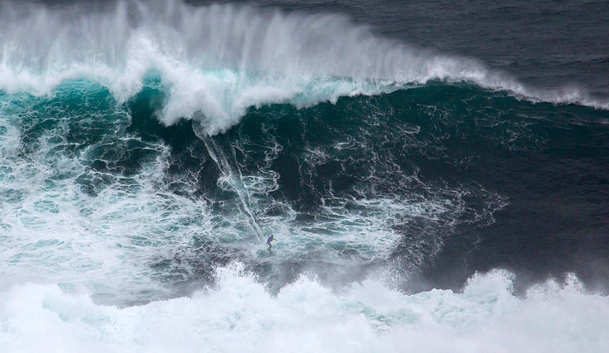 Pedro \"Scooby\" Viana (Rio de Janeiro, Brazil) is towed into a huge, stormy wave off Nazare, Portugal on October 27, 2015. One of the biggest waves successfully ridden so far this year, the ride has been entered into the TAG Heuer XXL Biggest Wave category of the 2016 WSL Big Wave Awards which will take place next April.  High surf episodes are expected to increase in severity this winter due to an exceptionally strong El Nino weather condition. Photo: WSL / Vitor Estrelinha