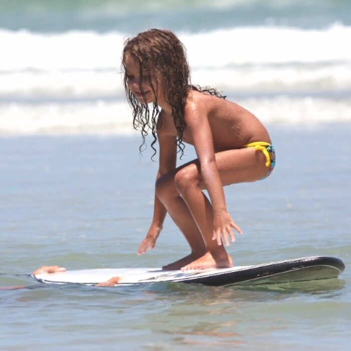 Surfing in the Gulf Coast is a family affair. Shea Lopez teaches his daughter Lina to surf. Photo: Tupat