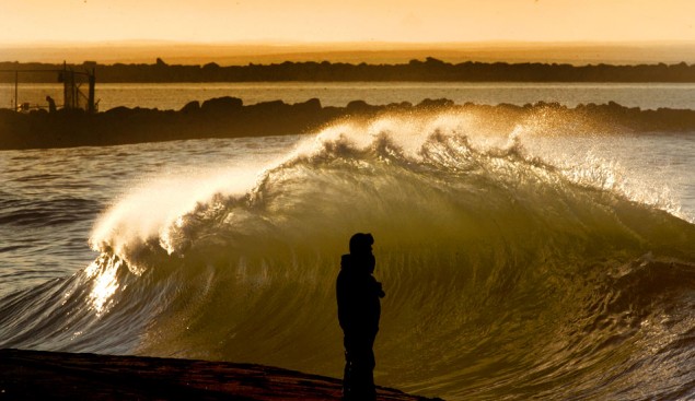 Surfer Watches Waves