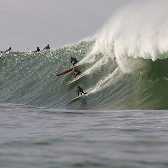 Party wave at Mavericks 2010. Todd Tissue, Ryan Augenstein and Tyler Fox
