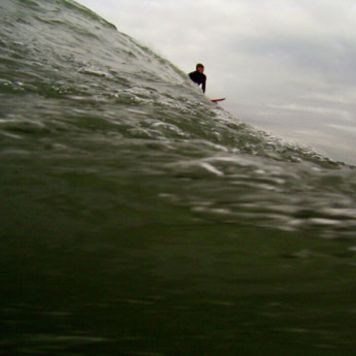 "When the first green wall—tall as a four-story building—marches off the horizon and pushes onto the reef, the base of the wave – the cauldron, as it’s called – drops below sea level, sucking in its gut." Photo: Mark Lukach