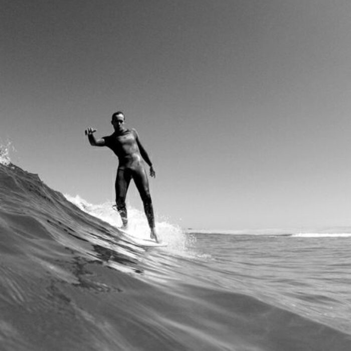 Finally, I popped to my feet and threw my weight into a careening turn that switched all my leftward momentum into a swift right-hand track, ran to the nose of the board and sped across the racing lip of the wave.