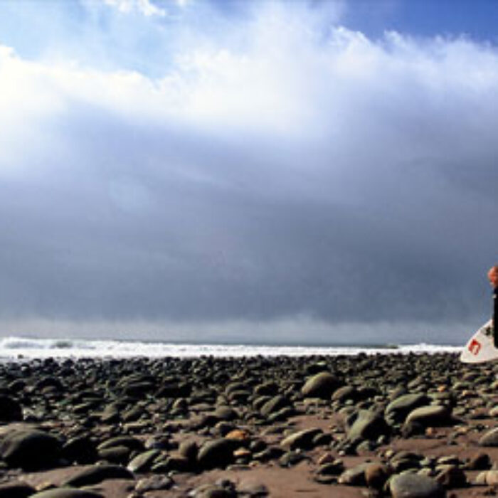 Kelly Slater in the flesh walking on the rocks out to Lower Trestles. Photo: Aroyan