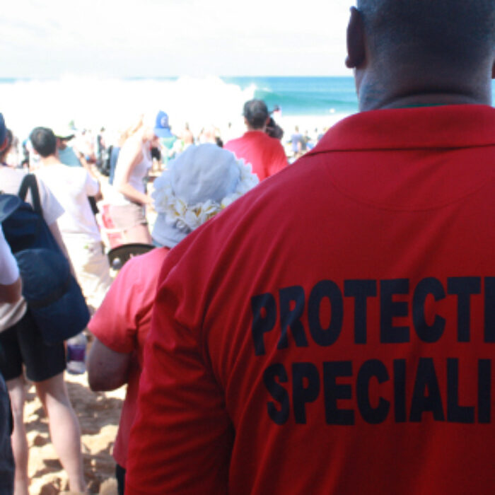 At The Billabong Pipeline Masters, there are some enormous men that, according to their shirts, are Protection Specialists. They stand with their arms crossed, looking intimidating. And it works. They are intimidating. These are the men that keep a watchful eye over the contest and their home.