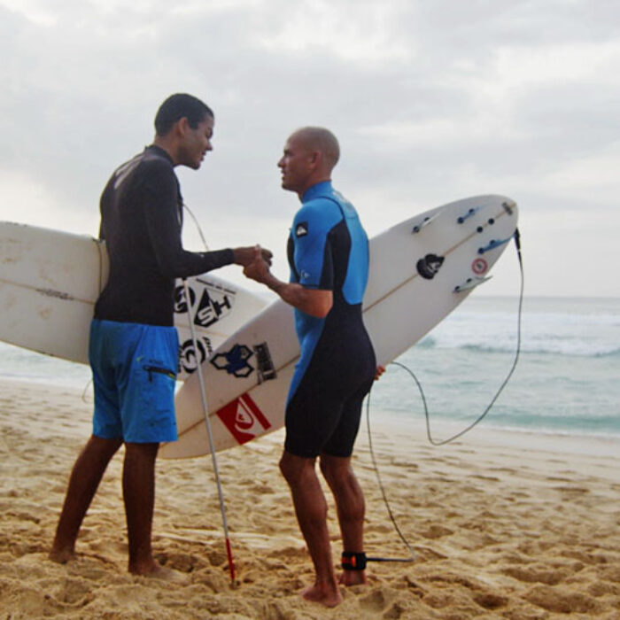 Blind surfer Derek Rabelo gets a few tips from the king, Kelly Slater.
