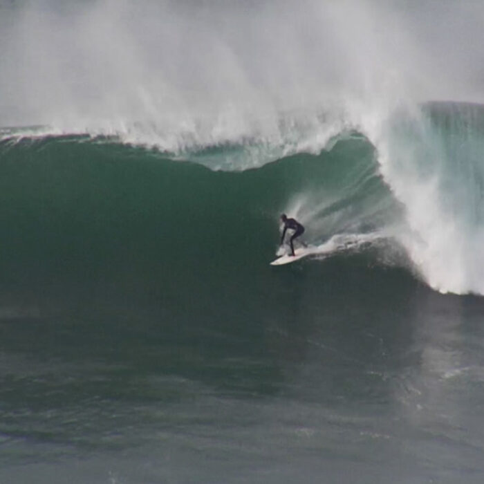Alex Gray surfs big waves.