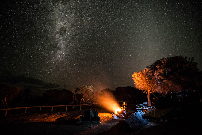 Scenes from a campfire. Cinematographer Darren McCagh at day's end on location somewhere on the far south coast of Western Australia during the filming of One Shot. Photo: Russell Ord
