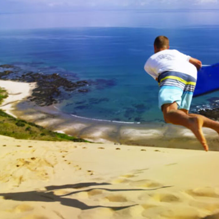 Whether or not you're one of those people that screams "DICK DRAGGER!" at the ten-year old in the neon yellow rash guard, it's pretty hard to deny that sponging down a massive New Zealand sand dune looks ridiculously fun.