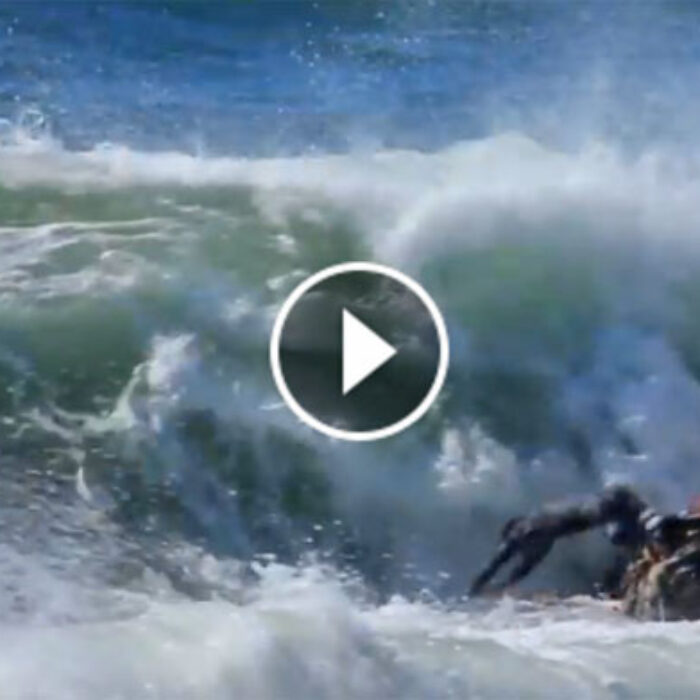 Miguel Blanco dives headfirst into rocky waters.