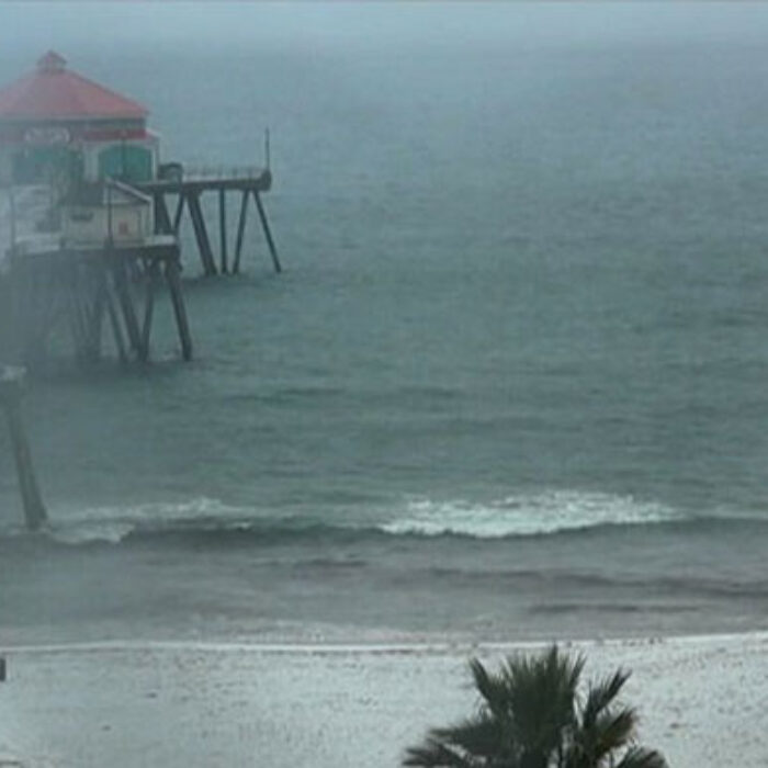 Beachgoers ran to lifeguard stands for cover, and more showers are expected over Southern California. A rare winter warning is in effect for many areas. Photo: Surfine