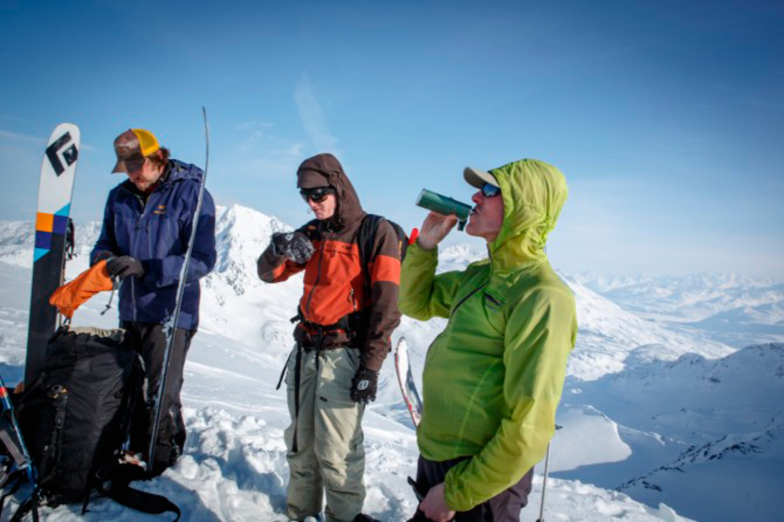 The crew enjoys some refreshments on the summit of cracked ice. The peaks in the background are what locals affectionately refer to as the “far-far gnar-gnar”. Photo: Spencer James