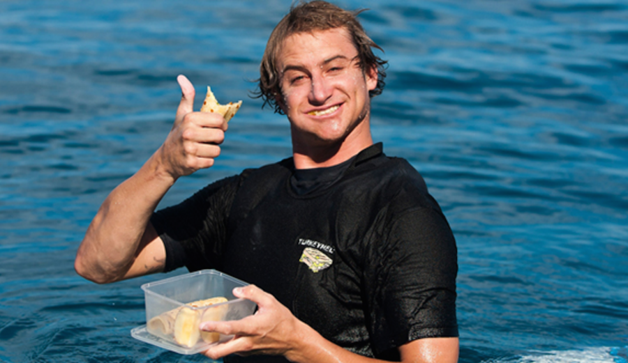 Alex Gray, never not smiling as he grabs a bite to eat mid-session. Photo: Tom Servais