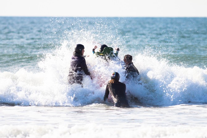 Getting the board through the waves takes teamwork