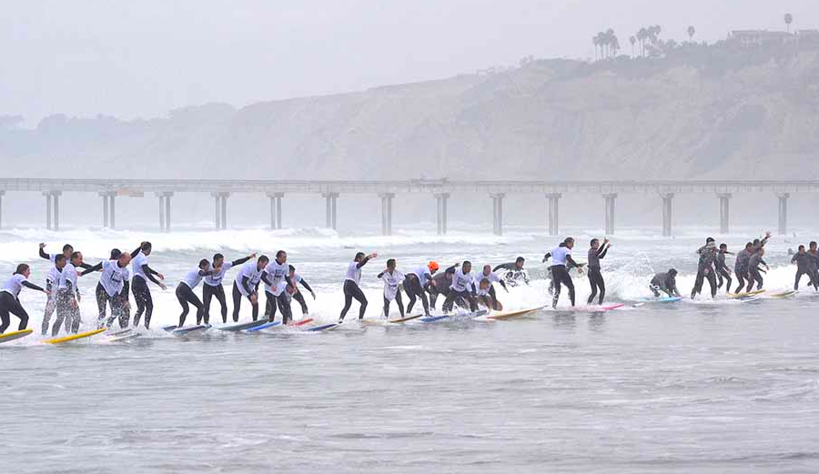 Nearly 100 surfers stand up on the same wave from Saturday's World-Record-Breaking attempt in La Jolla. Photo: Chris Stone / Times of San Diego