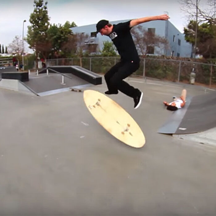 This guy did a kickflip on a surfboard with wheels on it.