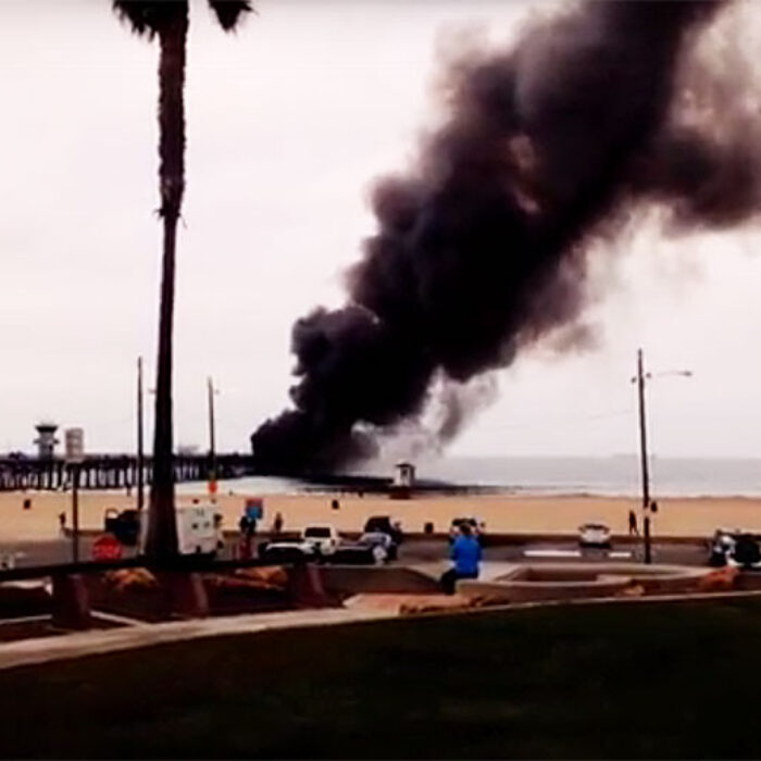 The smoke plume from the fire billowed high into the air, attracting onlookers to the blaze.