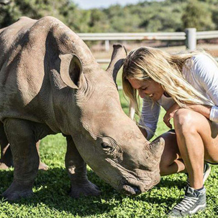 Stephanie Gilmore with a baby rhino whose mother was killed by assholes so other assholes can buy horns.