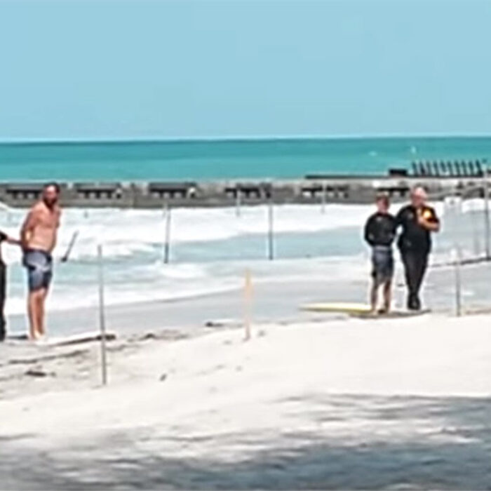 Three surfers detained for surfing near a submerged hazard.