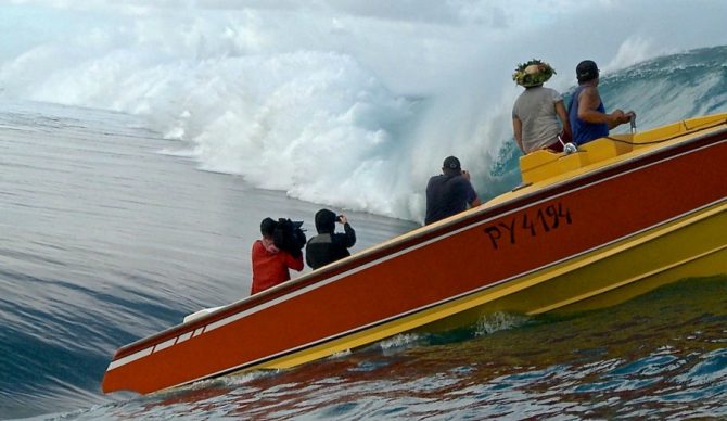 Tim Bonython, one of the lensmen in the boat, at work on a big swell at Teahupoo. Photo: Tim Bonython