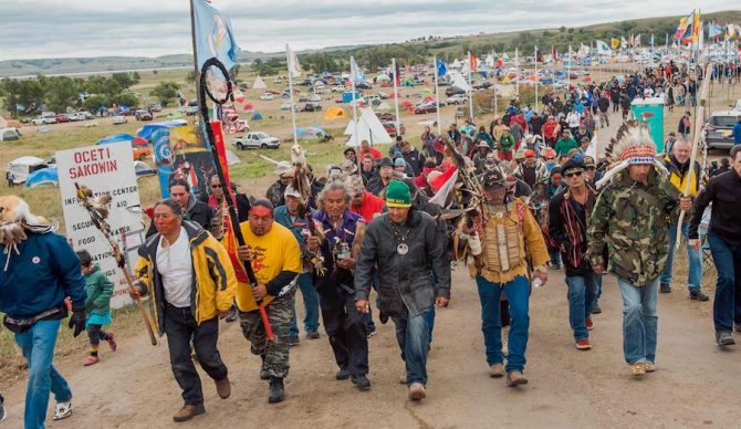 Protesters have been at it for months seeking to halt construction of the Dakota Access Pipeline through their tribal lands. Days ago Kamalei Alexander and a group of surfers joined them. Photo: The Guardian