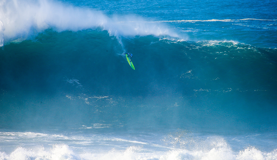 Jamie Mitchell flies down the face of a screamer at the 2016 Nazaré Challenge. The event is on Yellow Alert for a potential run on Friday. Photo: WSL / Laurent Masurel