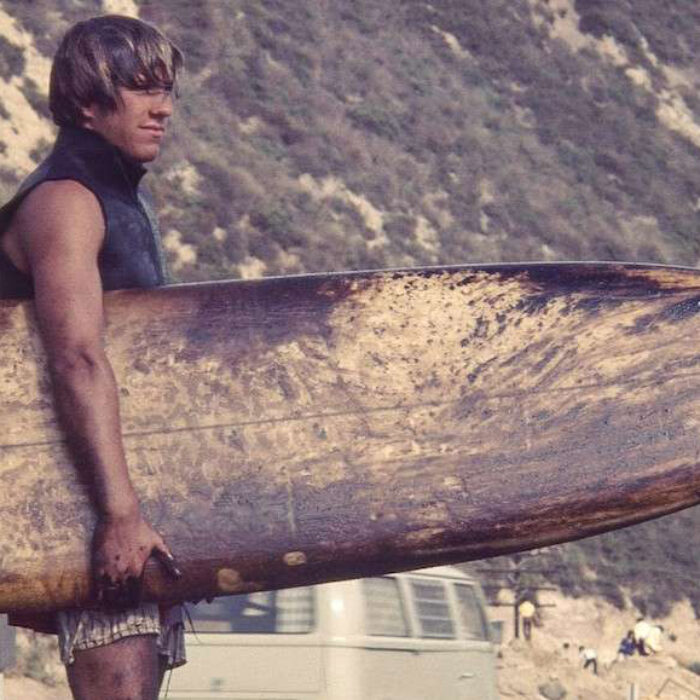 A Santa Barbara surfer covered in oil following the 1969 spill. Courtesy of Bud Bottoms
