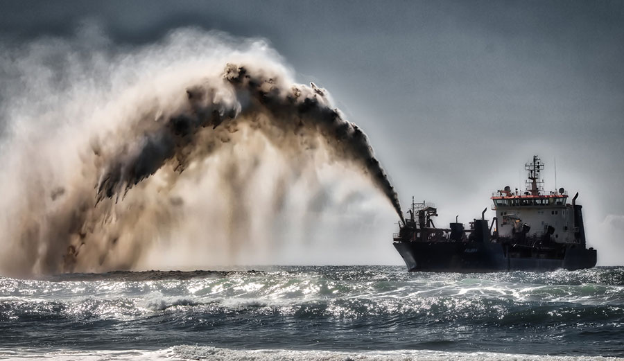 Dredger pumping sand and water to shore for beach renourishment, Mermaid Beach, Gold Coast, Australia, Aug. 20, 2017