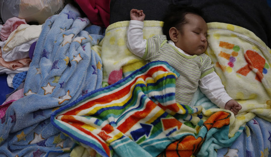 Three-month-old Erik Abdiel sleeps on a mattress on a gymnasium floor on Sept. 25, days after the earthquake in Mexico City. Twelve members of his family lost their homes and all belongings.