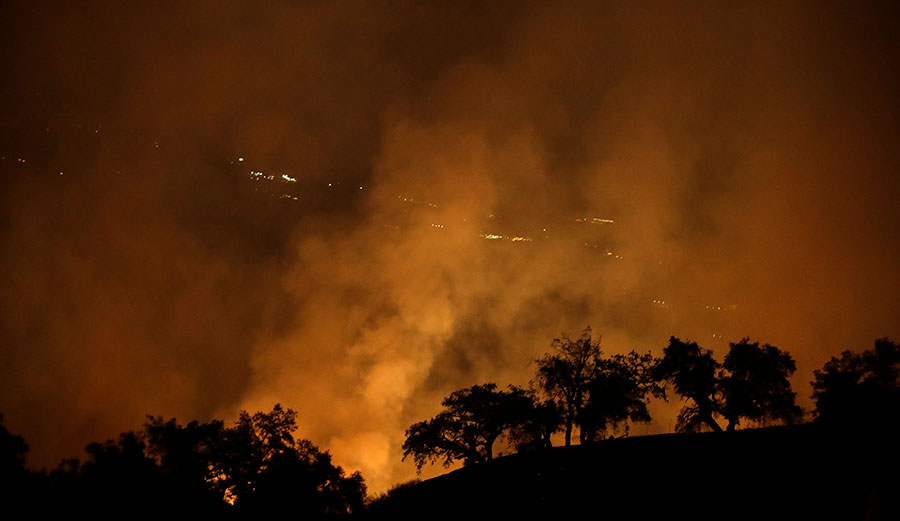 Wildfire creates an orange glow in a view from a hilltop Oct. 13, 2017, in Geyserville, California.