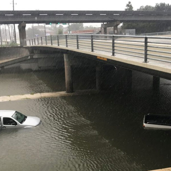 Vehicles sits half submerged in flood waters under a bridge in the aftermath of Hurricane Harvey. Photo: PBS