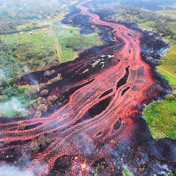 Saturday, May 19, 2018. A photo released by the U.S. Geological Survey shows lava flowing from fissures near Pahoa, Hawaii. Kilauea volcano began erupting more than two weeks ago and has burned dozens of homes, forced people to flee and shot up plumes of steam from its summit that led officials to distribute face masks to protect against ash particles. Image: U.S. Geological Survey via AP