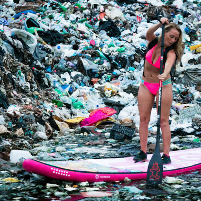 Alison Teal paddles through a sea of trash in Yucatan Mexico.