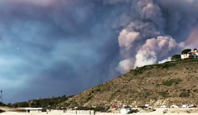 Smoke billows beyond the hills just behind Malibu's iconic First Point. Climate change is to blame. Photo: Instagram