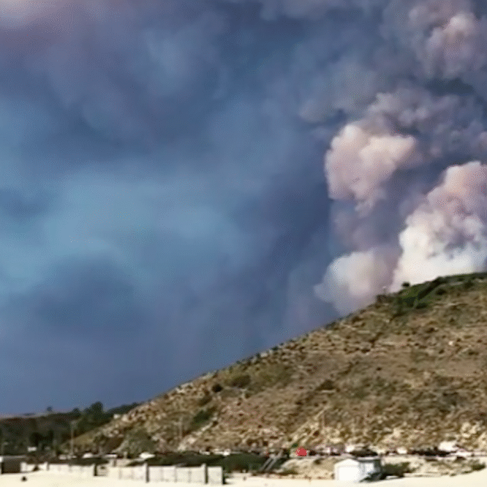 Smoke billows beyond the hills just behind Malibu's iconic First Point. Climate change is to blame. Photo: Instagram