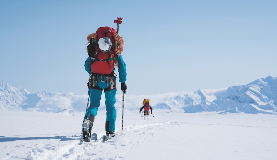 Jess Roskelley (blue) and David Lama (black) ski back to base camp after a recon of the 13,000' southeast face of Mount Logan. Yukon, Canada.