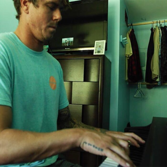 Albee Layer plays a Pixies cover as Nathan Fletcher, Filipe Toledo, and Julian Wilson surf across the screen.