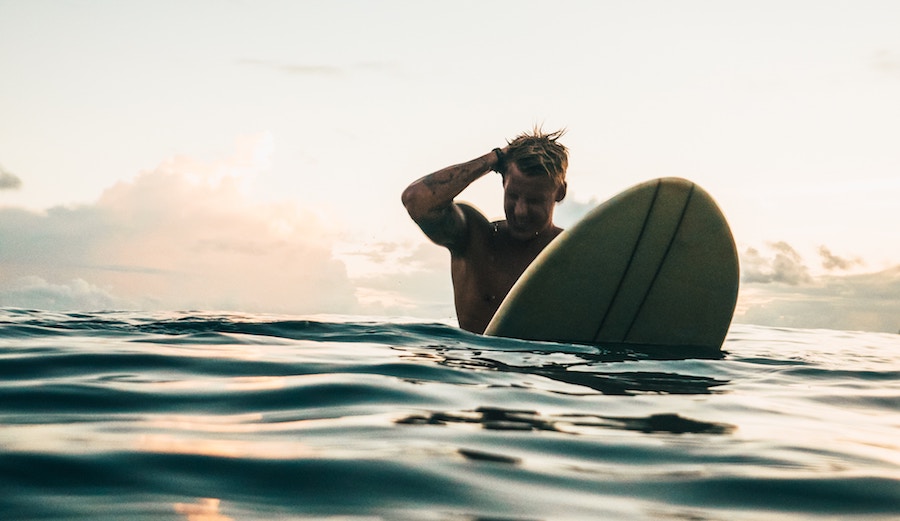 Surfer scratching head.