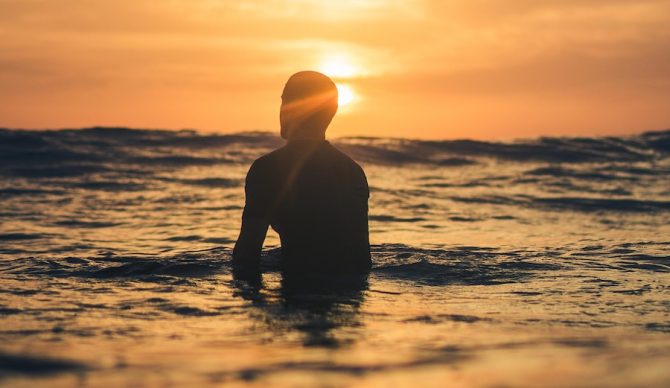Man waiting for wave. Dawn patrol.