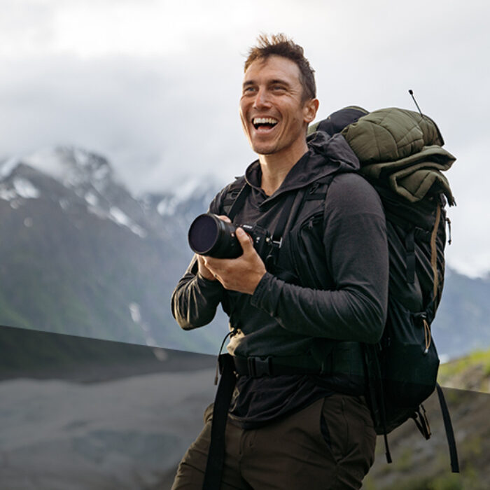 Photographer Chris Burkard smiling with his camera
