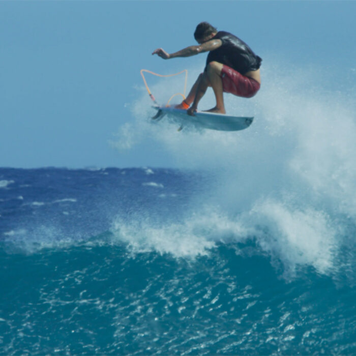 Albee Layer throws an air on a surfboard above a wave