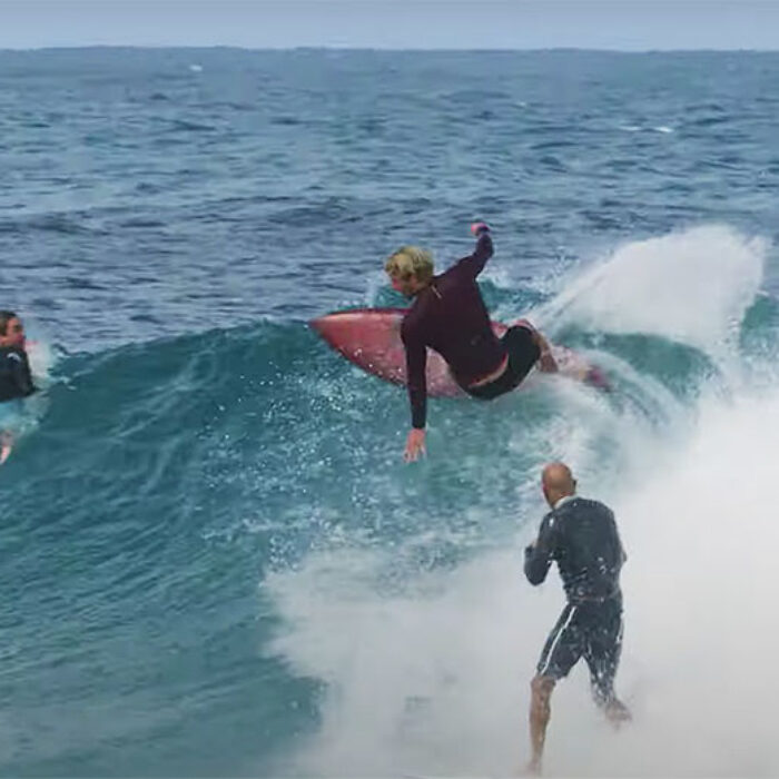 Kelly Slater and John John Florence surfing a wave together