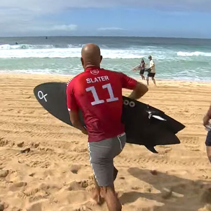 Kelly Slater running to beach at Pipeline