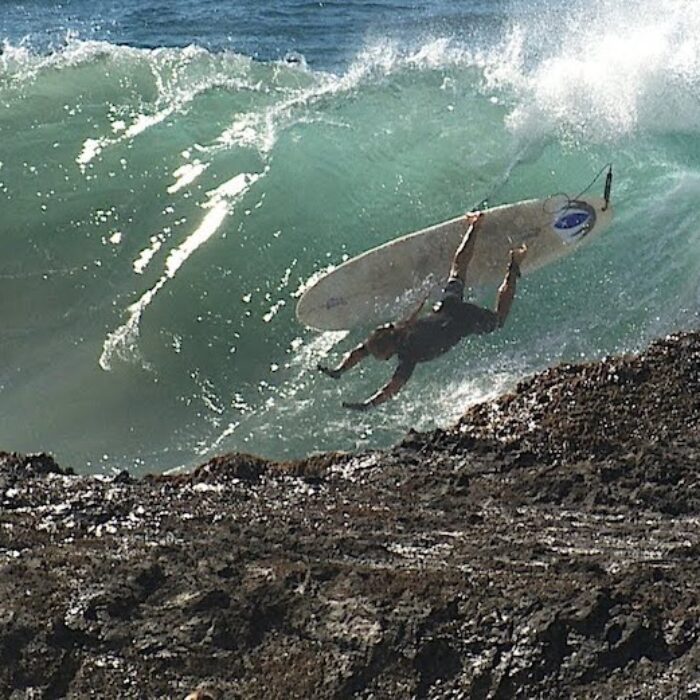 a surfer crashes at Snapper Rocks on the Gold Coast, Australia