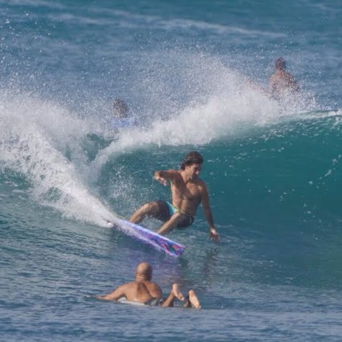 Mason Ho cuts back on a wave with Kelly Slater on the shoulder