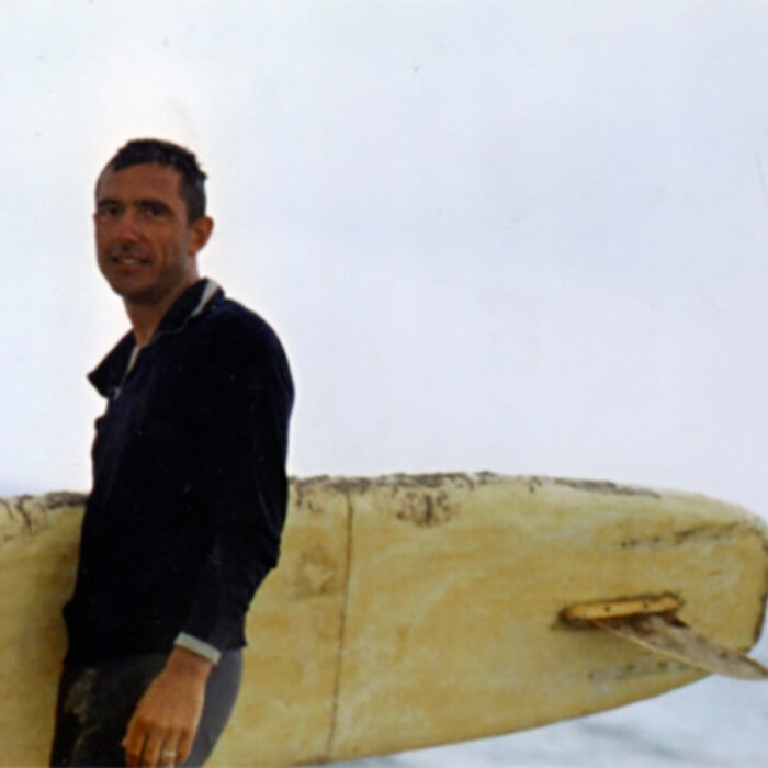 Russian surfer Nikolai Petrovich Popov holding a surfboard