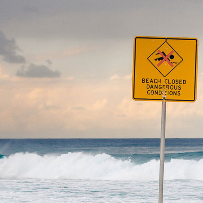 Beach closed sign on beach