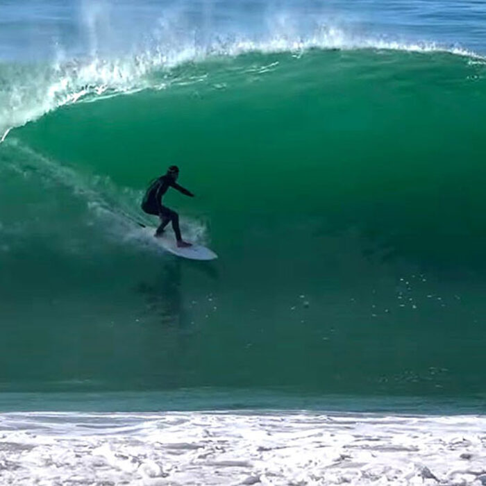 Surfer on a left barrel at Black's Beach