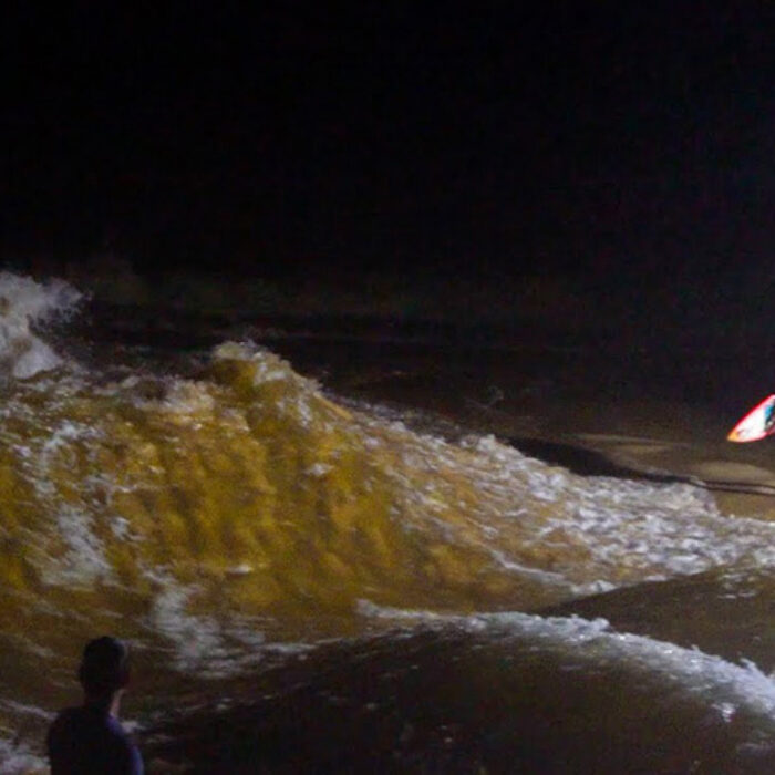 Jamie O'Brien looks at the Waimea Bay River wave